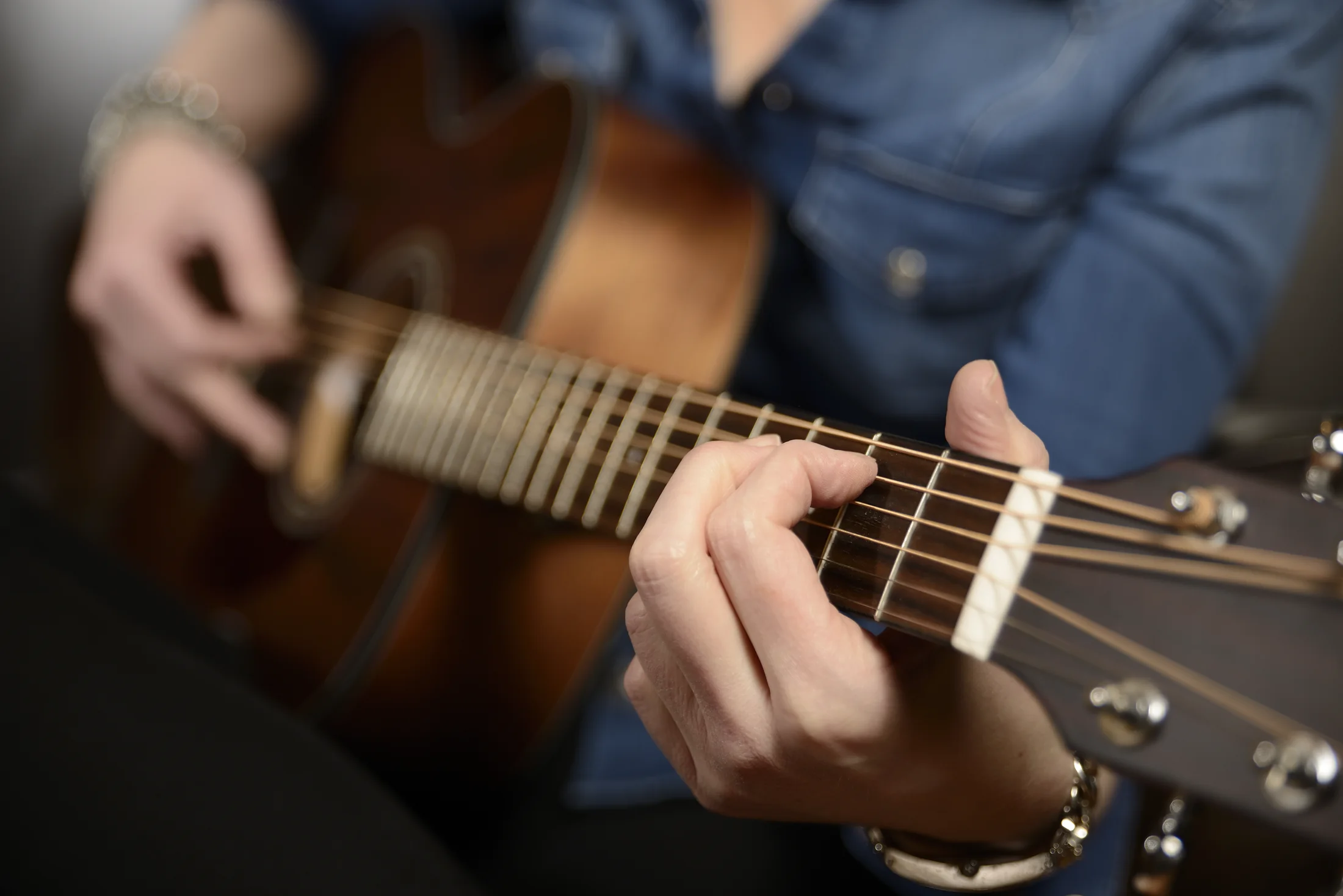 Detail of Vicky Beeching playing guitar during the DIVA editorial session